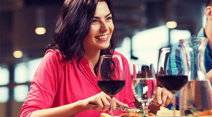 happy woman having dinner at restaurant