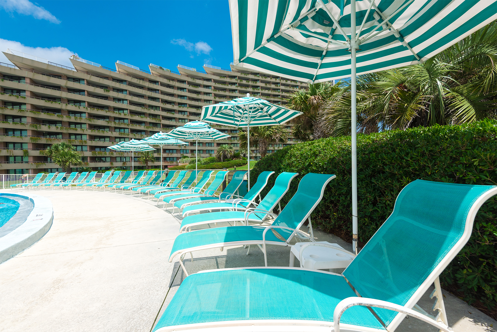 an image of pool chairs along the Edgewater condo pool