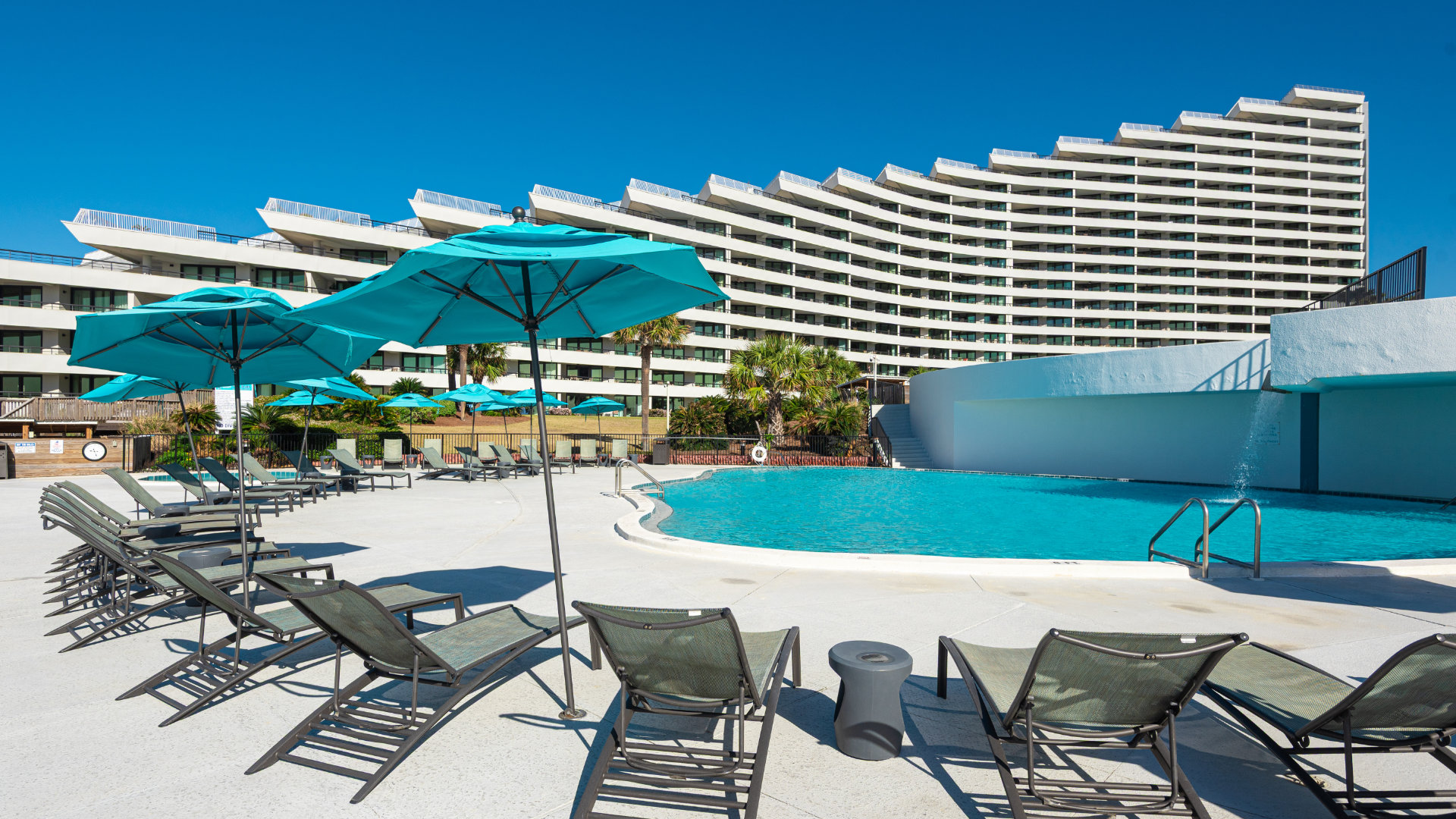 an image of pool chairs along the Edgewater condo pool